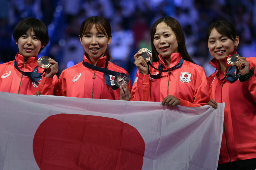 On the seventh day of the massive sporting event, the Japan team of Sera Azuma, Yuka Ueno, Karin Miyawaki and Komaki Kikuchi defeated Canada 33-32 to finish third. (AFP)