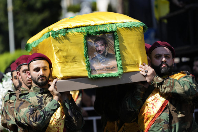 Hezbollah fighters carry the coffin of their commander Ali Jawad who was killed on Monday by an Israeli airstrike during his funeral procession, in Beirut, on Aug. 6, 2024. (AP)