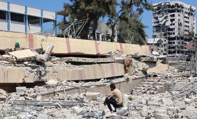 A man looks at the debris after an Israeli strike on a school, housing displaced Palestinians, in the Rimal neighborhood of central Gaza City on August 20, 2024. (AFP)