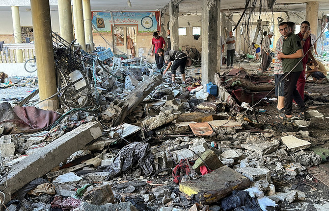 Palestinians react at the site of an Israeli strike on a school sheltering displaced people, amid the Israel-Hamas conflict, in Gaza City, August 10, 2024. (Reuters)