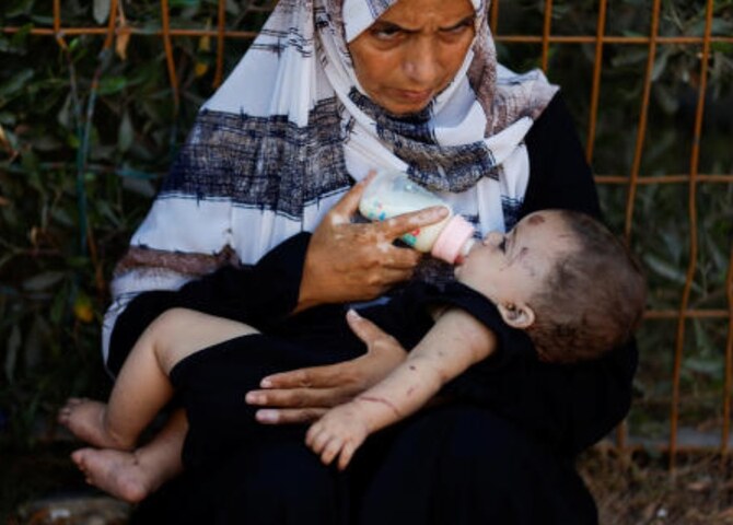 Reem Abu Haya, a Palestinian girl who survived an Israeli strike that killed her entire family, is fed by a relative at Nasser hospital, in Khan Younis in the southern Gaza Strip Aug. 13, 2024. (Reuters)