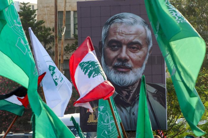 A portrait of slain Hamas leader Ismail Haniyeh is displayed during a a demonstration denouncing his killing and that Hezbollah's senior commander, in the Lebanese coastal city of Sidon. (File/AFP)