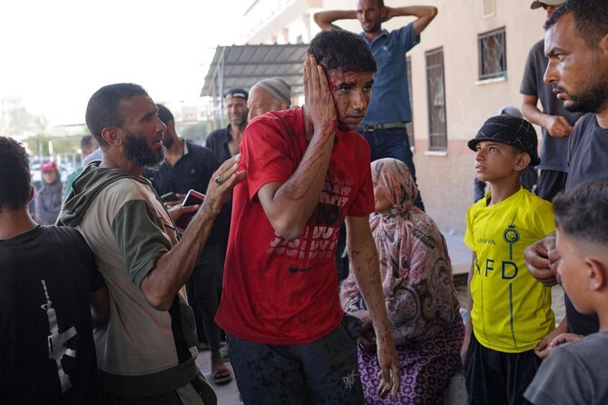 An injured Palestinian man is rushed to the Nasser hospital following Israeli bombardment on Khan Yunis in the southern Gaza Strip on August 14, 2024. (AFP)