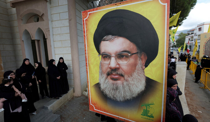 People stand near a picture of Hezbollah leader Sayyed Hassan Nasrallah in Kfar Melki, Lebanon September 19, 2024. (REUTERS)