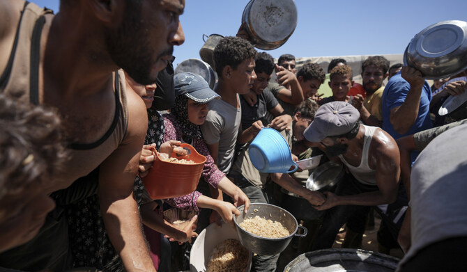 Displaced Palestinians gather for food distribution in Deir al Balah, central Gaza Strip, Aug. 23, 2024. (AP)