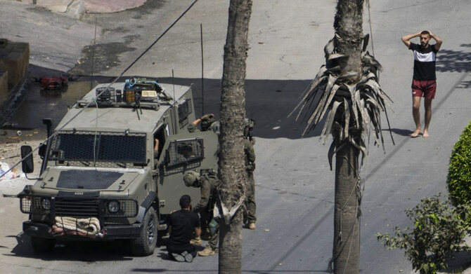 Israeli soldiers arrest a Palestinian man during a military operation in Jenin, West Bank, Thursday, Sept. 5, 2024. (AP)