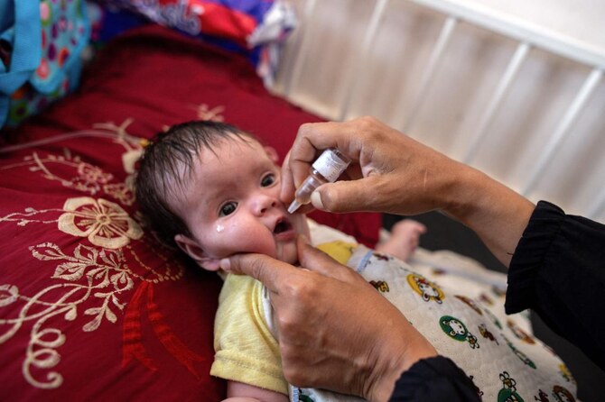A nurse administers Polio vaccine drops to a young Palestinian patient at the Nasser hospital in Khan Yunis in the southern Gaza Strip on August 31, 2024, amid the ongoing conflict between Israel and the Hamas militant group. (AFP)