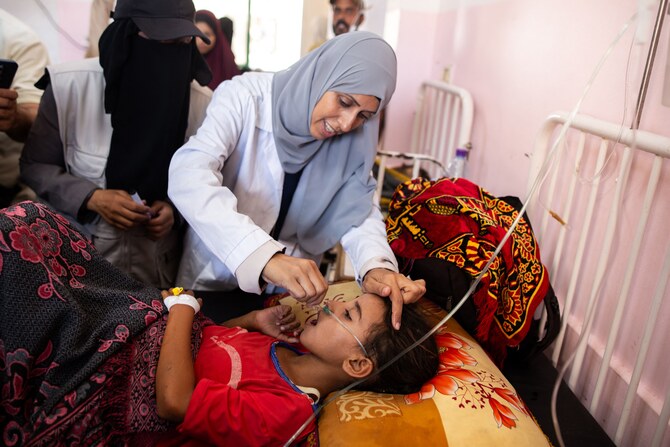 A nurse administers Polio vaccine drops to a young Palestinian patient at the Nasser hospital in Khan Yunis in the southern Gaza Strip on August 31, 2024, amid the ongoing conflict between Israel and Hamas. WHO said Israel agreed to at least three days of humanitarian pauses in parts of Gaza, starting on Sunday, to facilitate a vaccination drive after the territory recorded its first case of polio in a quarter of a century. (AFP)