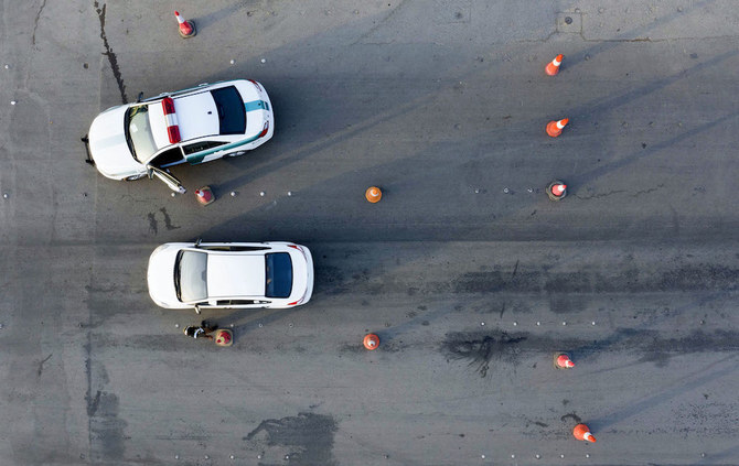 Above, Saudi police cars at a junction on the King Fahad road on May 24, 2020. Saudi Arabia has heavy penalties for drug-related crimes. (AFP file photo)