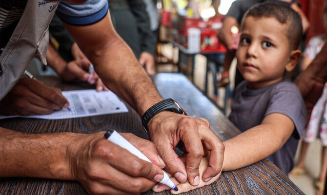 A health worker marks the finger of a child who received a vaccination for polio in Deir el-Balah in the central Gaza Strip on September 4, 2024 amid the ongoing war in the Palestinian territory between Israel and Hamas. (AFP)
