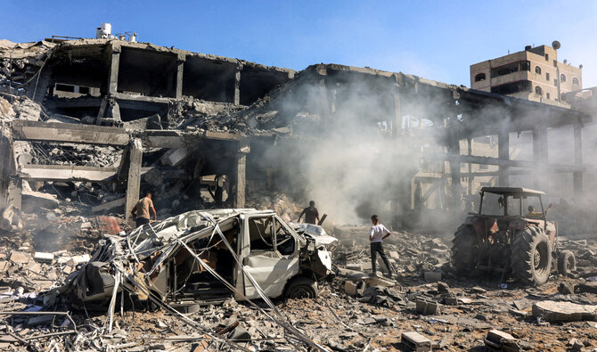 Men walk through debris in a building that was hit by Israeli bombardment in the Sheikh Radwan neighbourhood in the north of Gaza City on September 3, 2024. (AFP)