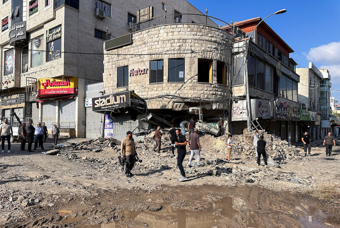 Palestinians assess the damage following an Israeli military operation in Jenin on Sept. 6, 2024. Many homes in Jenin camp were damaged or destroyed by army bulldozers and pavement was stripped from the roads. (Reuters)