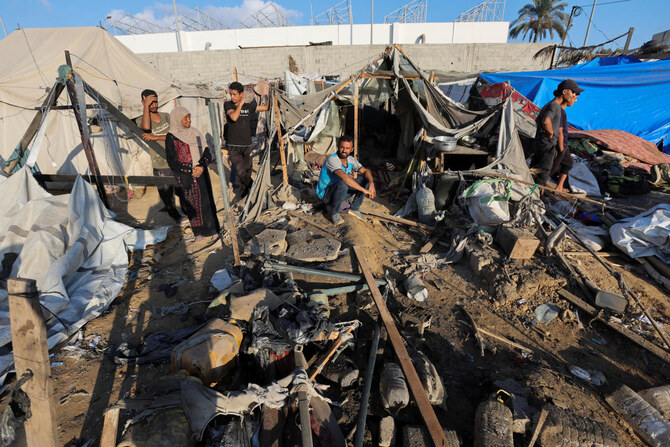 Palestinians inspect the damage at the site of an Israeli strike on the courtyard of Al-Aqsa Martyrs hospital, where displaced people were taking shelter in tents in Deir Al-Balah on Sept. 5, 2024. (Reuters)
