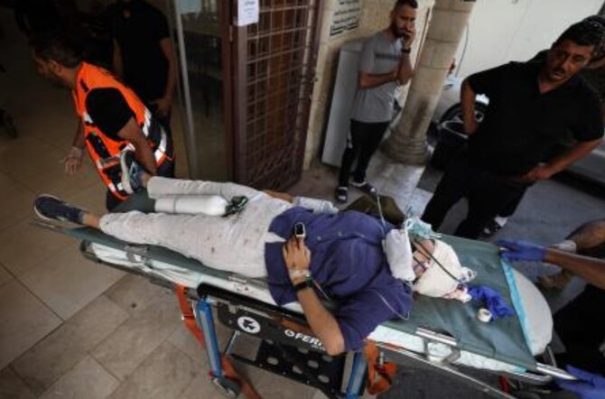 Medics rush a US citizen who reportedly received a gunshot wound in the head to the emergency ward of a hospital in Nablus in the occupied West Bank on Sept. 6, 2024. (AFP)