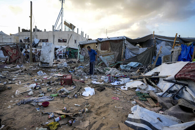 Palestinians inspect the damage at a tent area in the courtyard of Al Aqsa Martyrs hospital, hit by an Israeli bombardment on Deir al-Balah, central Gaza Strip. (File/AP)