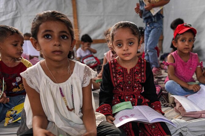 More than 90 percent of Gaza’s school buildings have been damaged by Israeli bombardment, many of them run by UNWRA. Above, children attend a class given by Palestinian teacher Israa Abu Mustafa in a makeshift room in Khan Younis in the southern Gaza Strip on Sept. 4, 2024. (AFP)