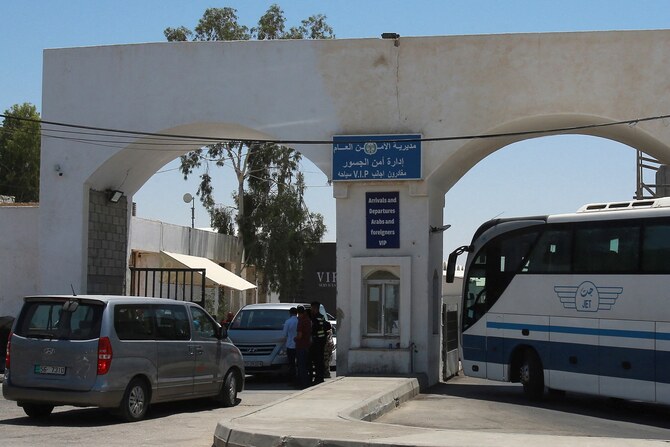 Vehicles queue at the Jordanian side of the King Hussein Bridge (also known as Allenby Bridge) crossing between the West Bank and Jordan on July 19, 2022. (AFP)