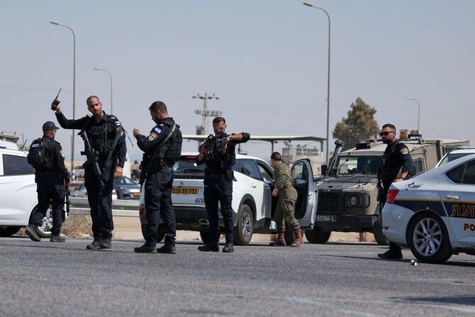 Israeli security forces gather at the scene of a reported attack near the Allenby Crossing between the occupied West Bank and Jordan on September 8, 2024, where the Israeli military said a truck driver opened fire, killing three Israelis. (AFP)