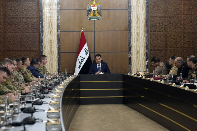 This photo taken on January 27, 2024, shows Iraqi PM Mohamed Shia al-Sudani (C) presiding over a meeting between Iraqi military officials representatives of the US-led coalition in Baghdad. (AFP/File)