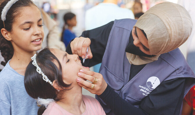 A Palestinian medic administers polio vaccines to youngsters at the Al-Daraj neighborhood clinic in Gaza City on Tuesday. (AFP)