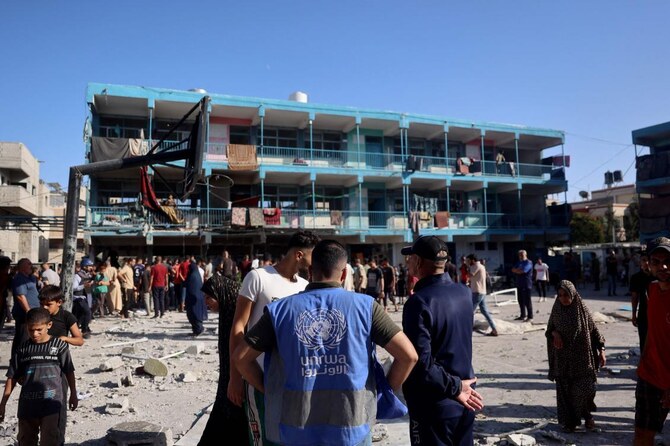 A member of the UNRWA checks the courtyard of a school after an Israeli air strike hit the site, in Nuseirat in the central Gaza Strip on Sept. 11, 2024. (AFP)
