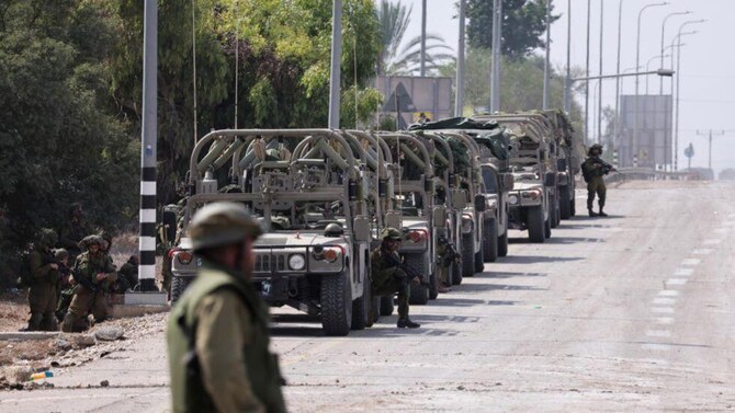 Israeli soldiers take up position in Kfar Aza, south Israel, bordering the Gaza Strip on October 10, 2023. (AFP)