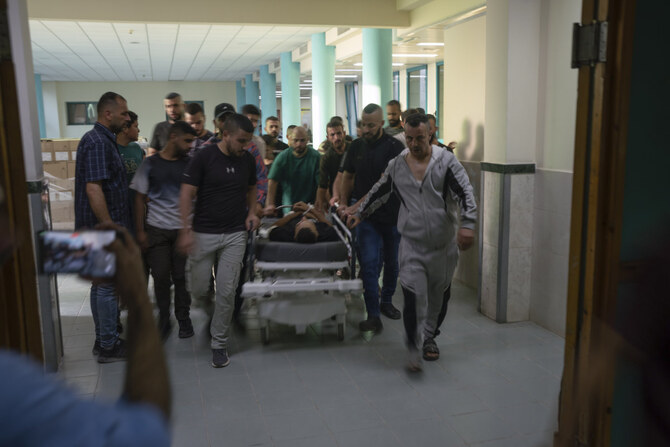 The body of Odei, a 22-year-old Palestinian militant, is carried into a morgue at the hospital in Jenin, West Bank, on June 6, 2024. (AP)