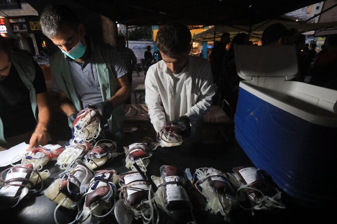 Medics collect blood donations in Beirut’s southern suburb on September 17, 2024, after explosions hit locations in several Hezbollah strongholds around Lebanon amid ongoing cross-border tensions between Israel and Hezbollah fighters. (AFP)