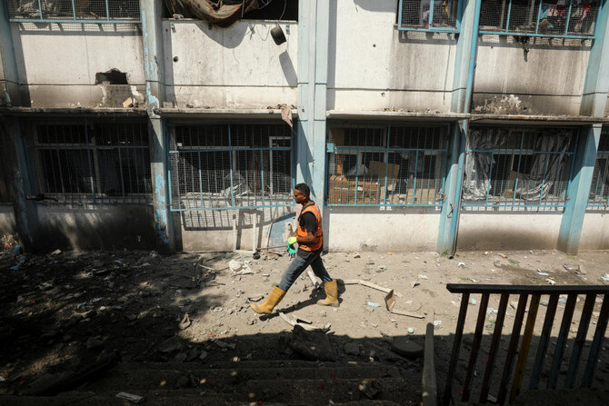 A Palestinian man walks on a street after a school, which was sheltering displaced people, was hit by an Israeli strike, amid the Israel-Hamas conflict, in Gaza City, September 21, 2024. (Reuters)