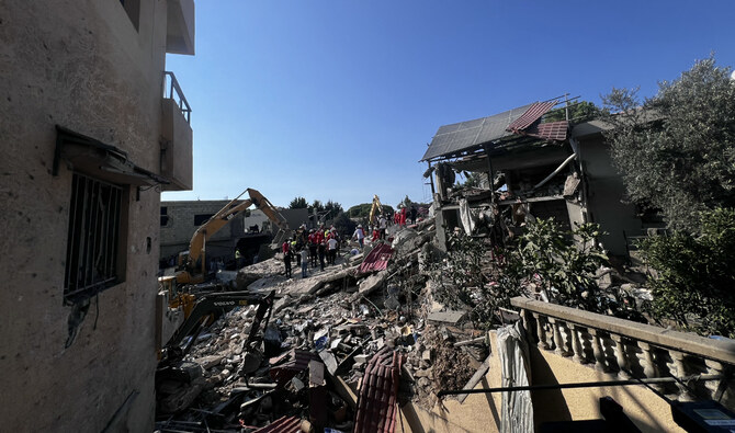 People gather at the site of an Israeli strike on the Mount Lebanon village of Maaysra, east of the Christian coastal town of Byblos, on September 25, 2024. (AFP)