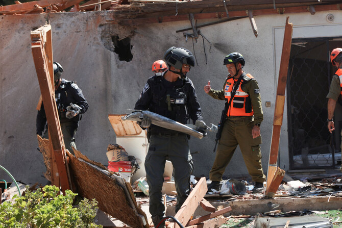 Israeli security forces remove debris from a rocket at the scene of a damaged home in northern Israel following a rocket attack from Lebanon on September 25, 2024. (REUTERS)