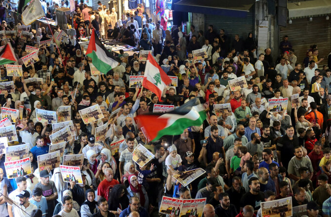 Demonstrators carry signs and flags during a protest in support of Lebanon and Gaza, in Amman, Jordan, on Sept. 27, 2024. (REUTERS)