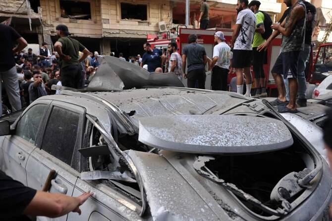 People check the damage following an Israeli strike in Beirut's southern suburbs on September 20, 2024. The Israeli military announced that the commander of Hezbollah's elite Radwan unit, Ibrahim Aqil, and other senior figures of the Lebanese armed group had been killed in the air strike. (AFP)