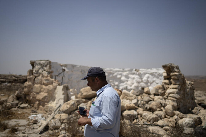 Fayez Suliman Tel, head of the village council for Khirbet Zanuta, stands next to a home that was destroyed when his community was driven out by Israeli settlers, Tuesday, Aug. 27, 2024. (AP)