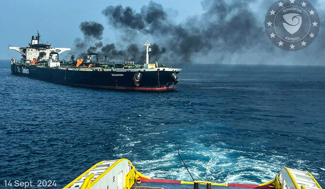 This handout picture provided by EUNAVFOR ASPIDES on September 15, 2024, and dated September 14, shows a vessel with a rope extended toward the Greek-owned oil tanker Sounion as smoke and fire billows from it, off the coast of Hodeida in the Red Sea. (AFP)