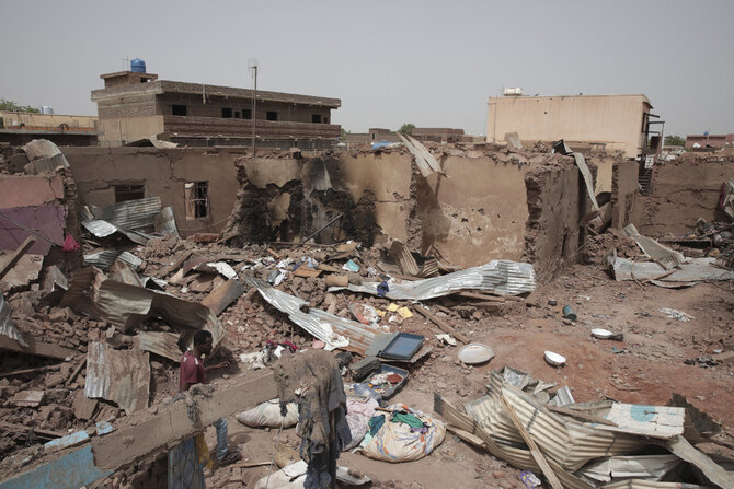 A man walks by a house hit in recent fighting in Khartoum, Sudan, an area torn by fighting between the military and the notorious paramilitary Rapid Support Forces. (AP/File)