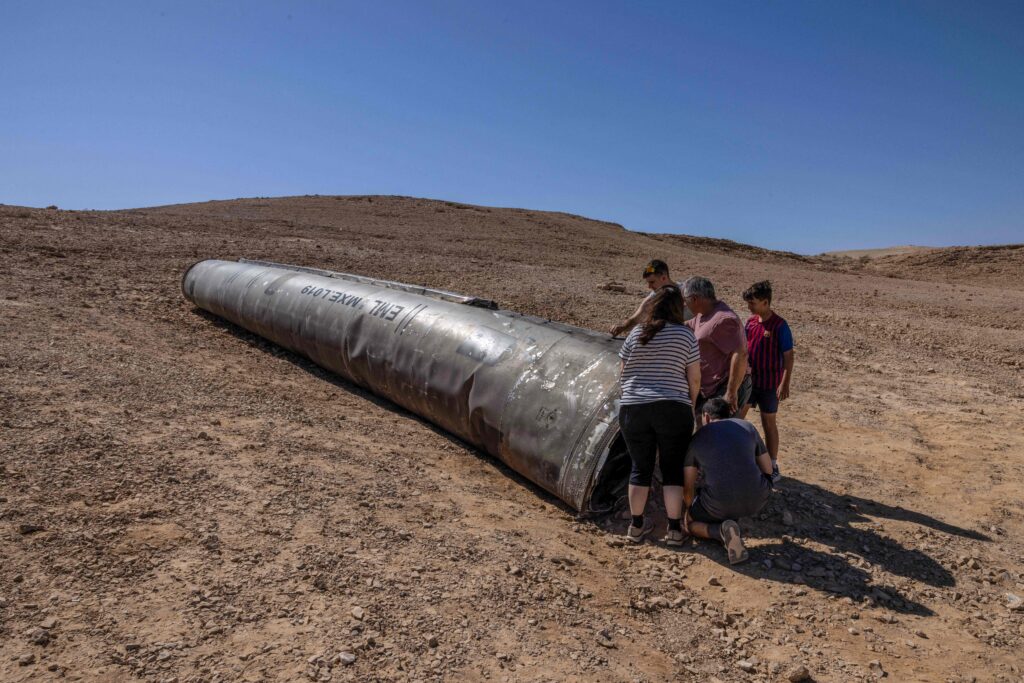 People visit the site of the remains of an Iranian missile in the Negev desert near Arad on October 3, 2024, in the aftermath of an Iranian missile attack on Israel. Israel vowed to make Iran