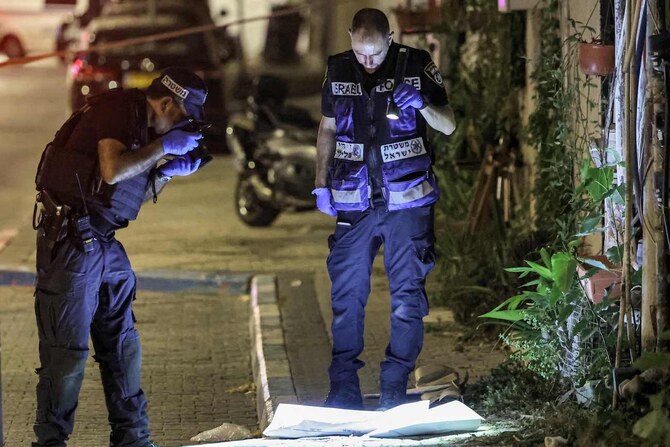 Members of the Israeli police's forensics department document the scene of a shooting attack in Jaffa, south of Tel Aviv on October 1, 2024. (AFP)