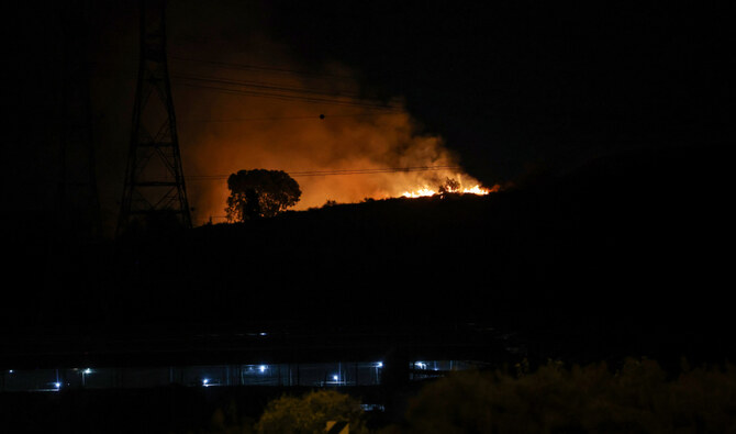 Fire erupts between Ben Gurion International Airport near Tel Aviv and the city of Modiin following an Iranian missile attack, on October 1, 2024. (AFP)