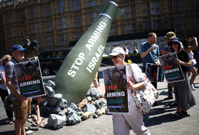 Pro-Israel supporters disrupt an installation by the charity Oxfam, depicting a Mark-84 2,000-pound bomb with the words 'Stop Arming Israel', opposite the Houses of Parliament in central London on July 30, 2024. (AFP)