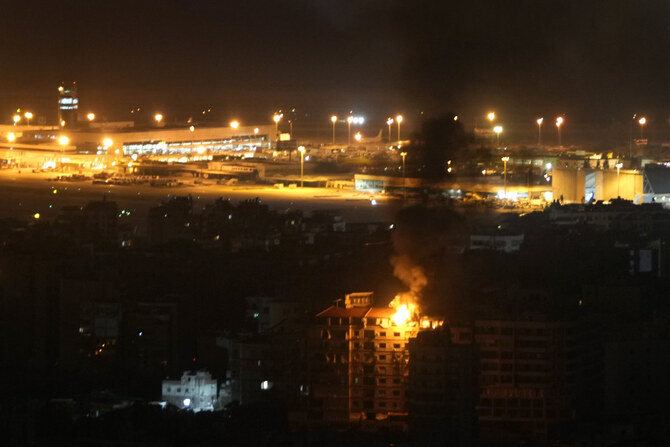 Flames and smoke rise from a building that was hit by an Israeli airstrike in Dahiyeh on Oct. 4, 2024, as Beirut's Rafik Hariri International airport is seen in the background. (AP)