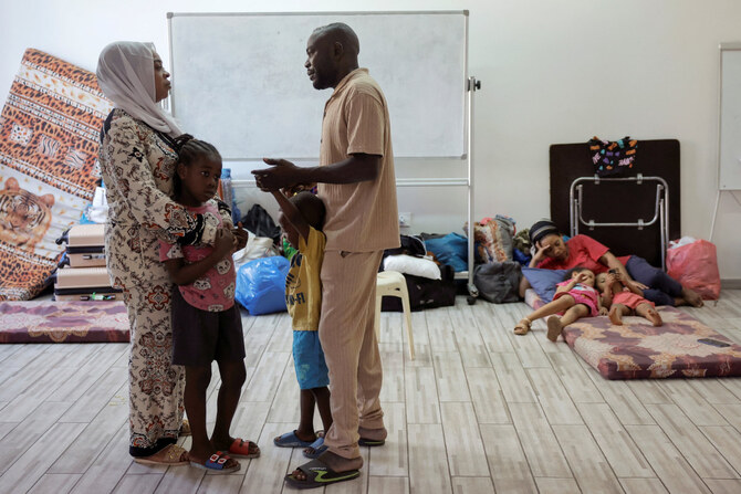 Mohamed Abdallah Amer, 40, visits his wife and children at a women's dormitory in the temporary shelter for migrants at St. Joseph Church in Beirut, Lebanon, on October 1, 2024. (REUTERS)
