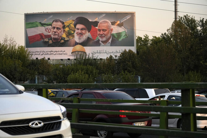Billboard in Tehran shows slain Hezbollah leader Hassan Nasrallah, late Hamas leader Ismail Haniyeh, and the late Iranian Revolutionary Guard Gen. Abbas Nilforushan, who was killed in an Israeli airstrike. (AP)