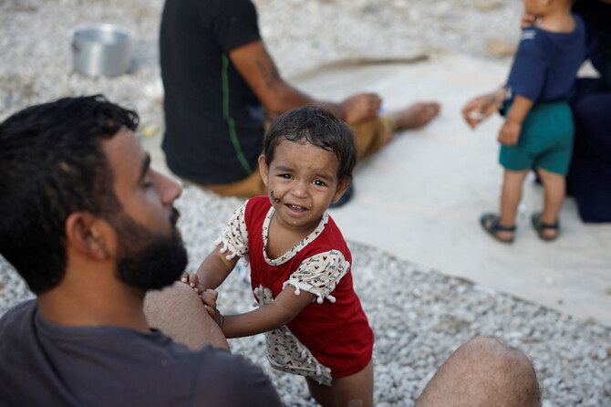 A child looks on while families sit in their temporary shelter in a park in the centre of the city, amid the ongoing hostilities between Hezbollah and Israel, in Beirut, Lebanon. (Reuters)