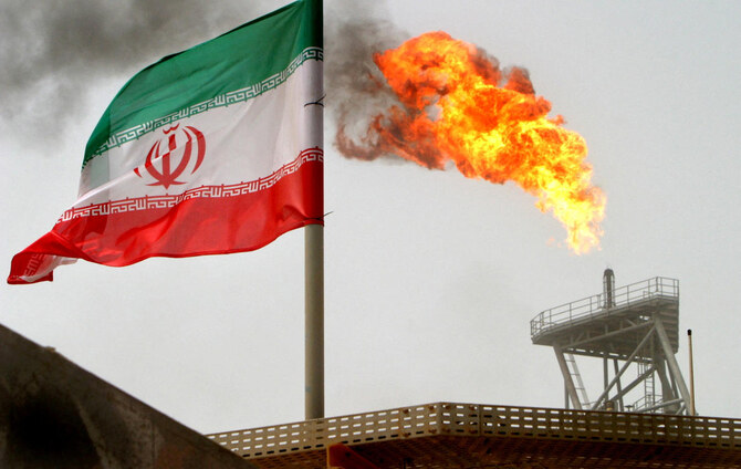 Above, a gas flare on an oil production platform is seen alongside an Iranian flag in the Gulf on July 25, 2005. (Reuters)