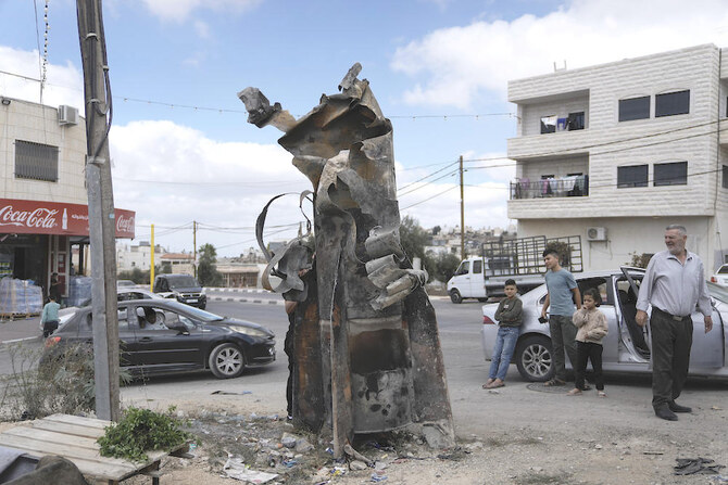 Palestinians inspect the debris of an Iranian missile intercepted by Israel in the West Bank city of Hebron Oct. 2, 2024. (AP)