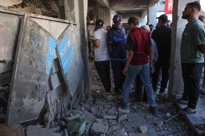 Displaced Palestinians check the damage inside UN school-turned-refuge in the Al-Shati refugee camp near Gaza City in the northern Gaza Strip, following a reported Israeli strike. (File/AFP)