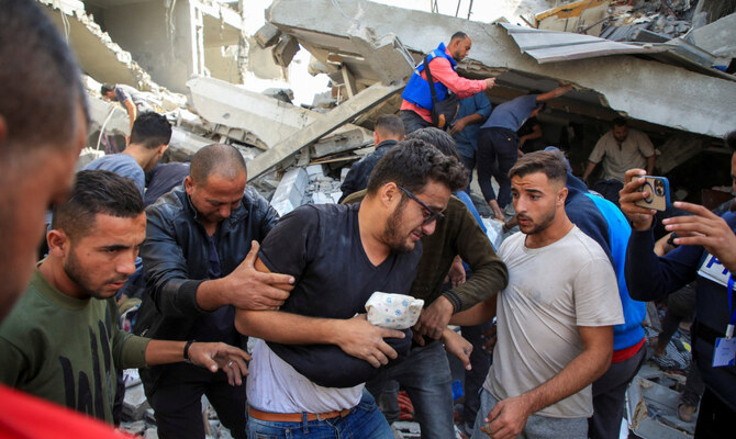 A Palestinian man is assisted at the site of an Israeli strike on a house, amid the ongoing Israel-Hamas conflict, in Gaza City, October 26, 2024. (Reuters)