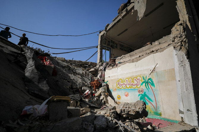 Palestinians view the damage at a school-turned-shelter hit in an Israeli strike on Sunday, amid the ongoing Israel-Hamas conflict, at Beach camp in Gaza City. (File/Reuters)
