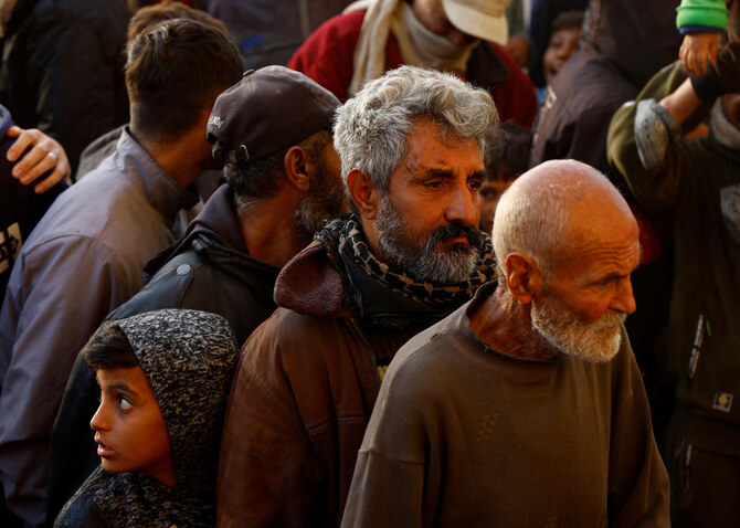 Displaced Palestinian man Abu Razzak Al-Qassas waits to buy bread from a bakery, amid the Israel-Hamas conflict, in Khan Younis, in the southern Gaza Strip. (Reuters)